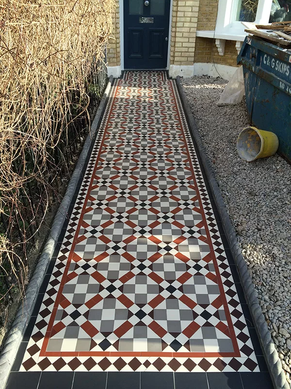 Victorian tiled path installers working on mosaic pathway in London